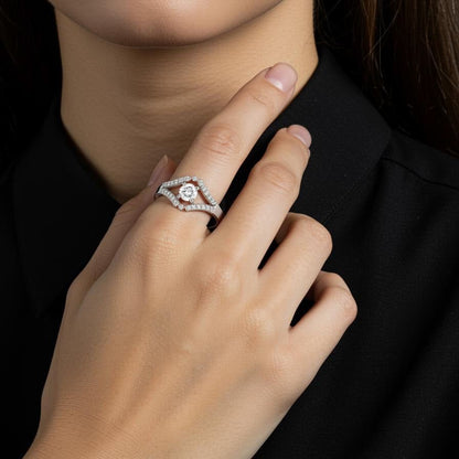 Close-up of a women hand wearing a silver ring on a black background