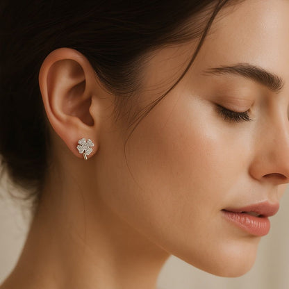 Close-up of a beautiful woman wearing a silver earring with a beige background, sterling silver earrings for daily wear and outings